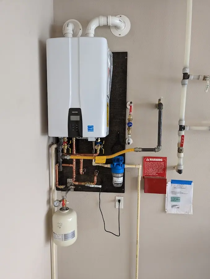 Professional plumber installing copper piping in a Gaylord home